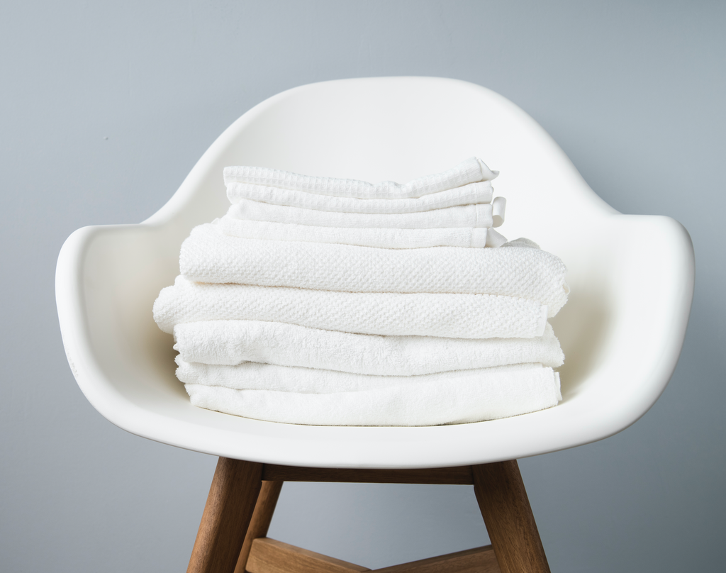 Stack of white towels in chair