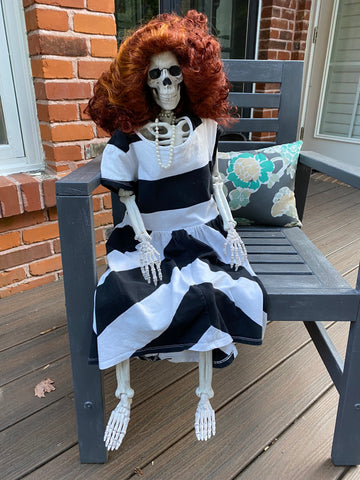 Skeleton dressed in wig and dress