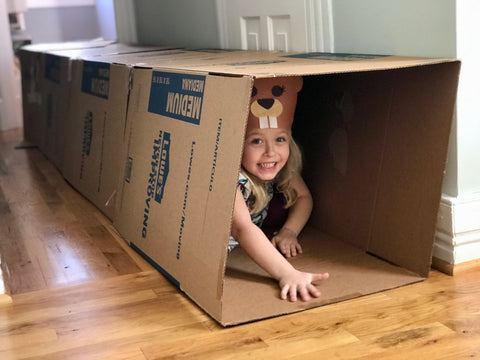 Child crawling through a box maze
