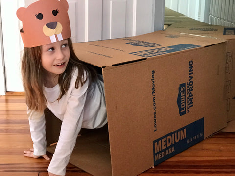 Child playing in box maze