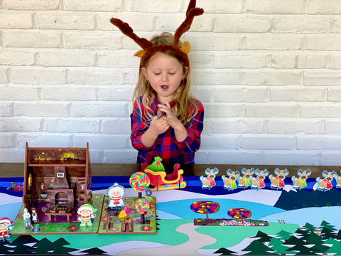 Child playing with Santa's workshop playset