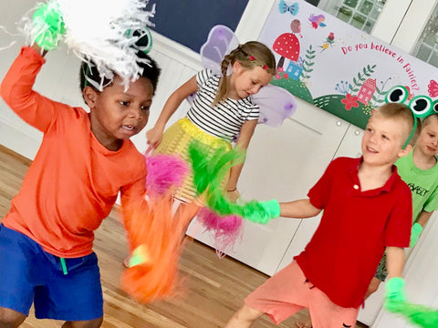 Boys and girls dancing with pom poms