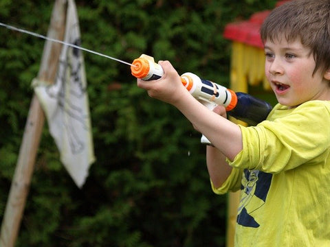 Boy shooting a water gun