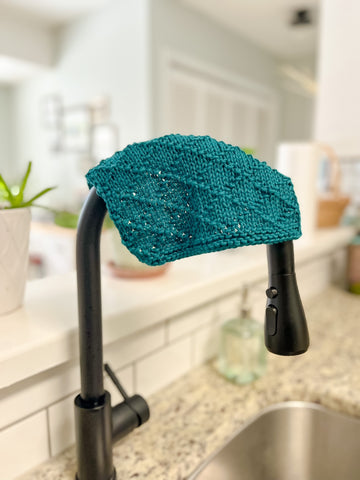 Facet Dishcloth hanging over a sink faucet.