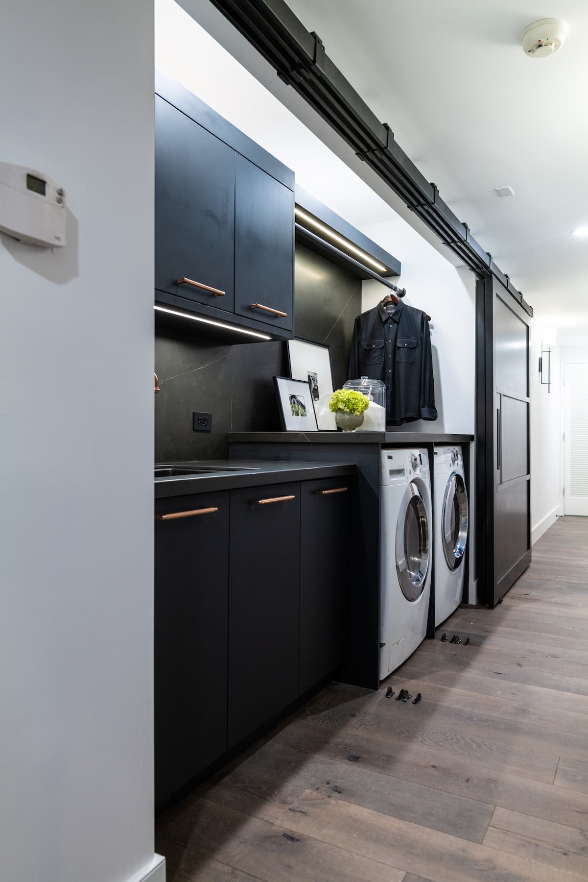 wide shot of laundry area with sliding barn door