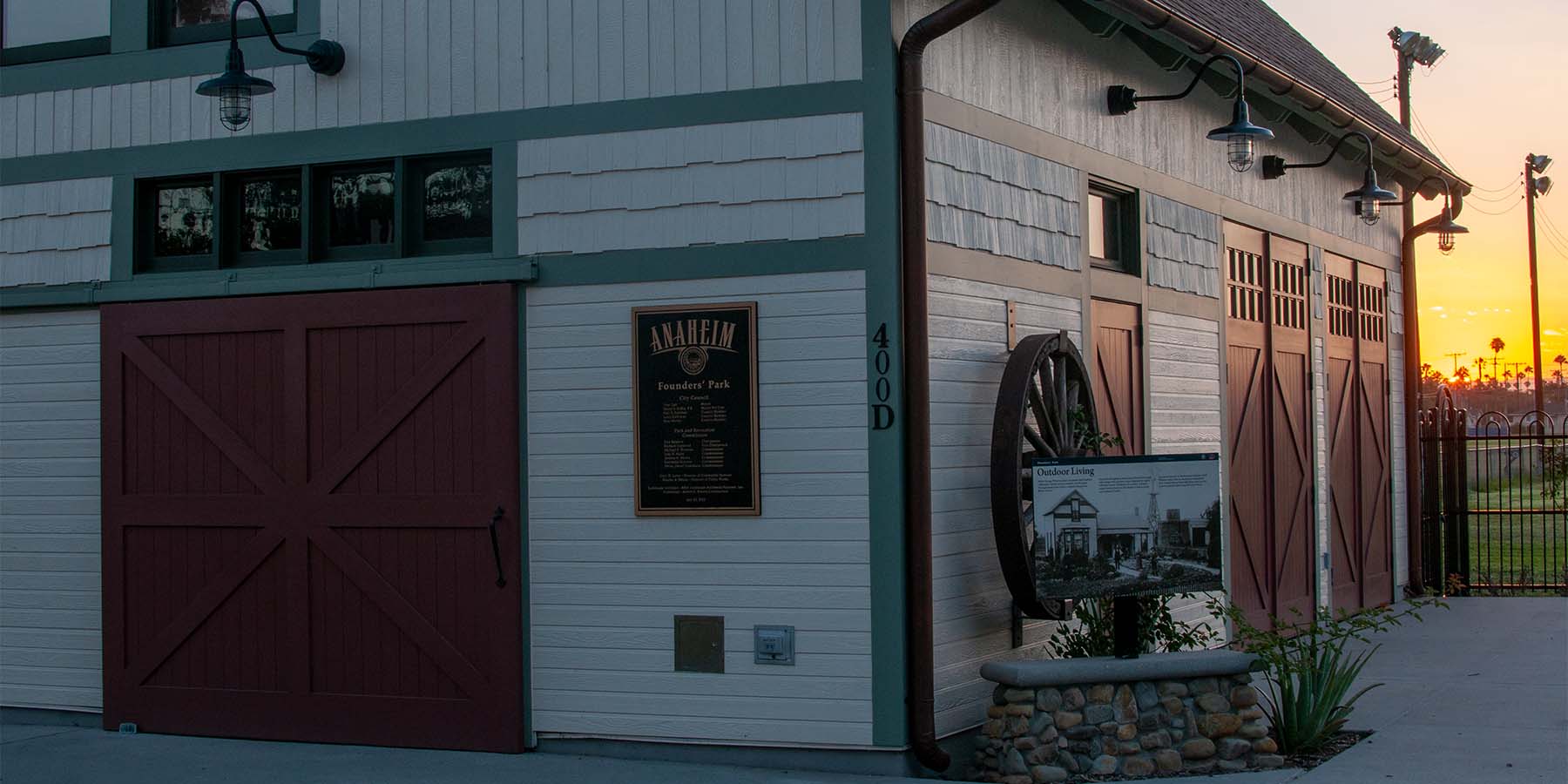 Close-up of carriage doors, sliding door, and entry door at the founders park during sunset.