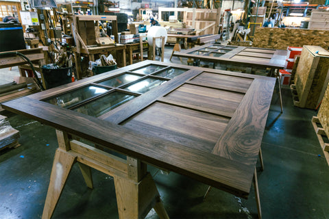 walnut carriage doors shown in the woodshop on sawhorses
