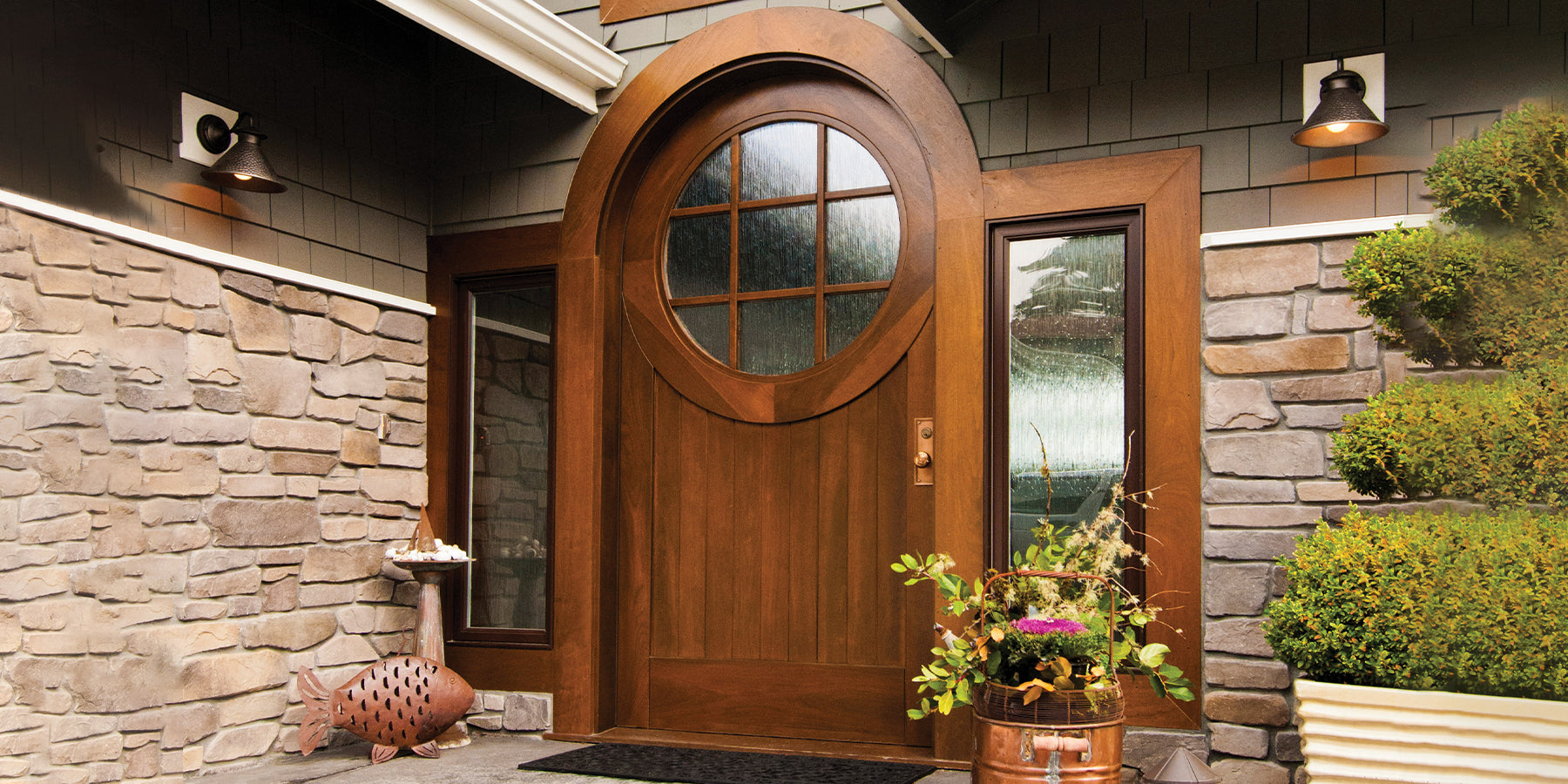 House entryway featuring a luxurious solid wood custom door design with la large circular window on the top area.