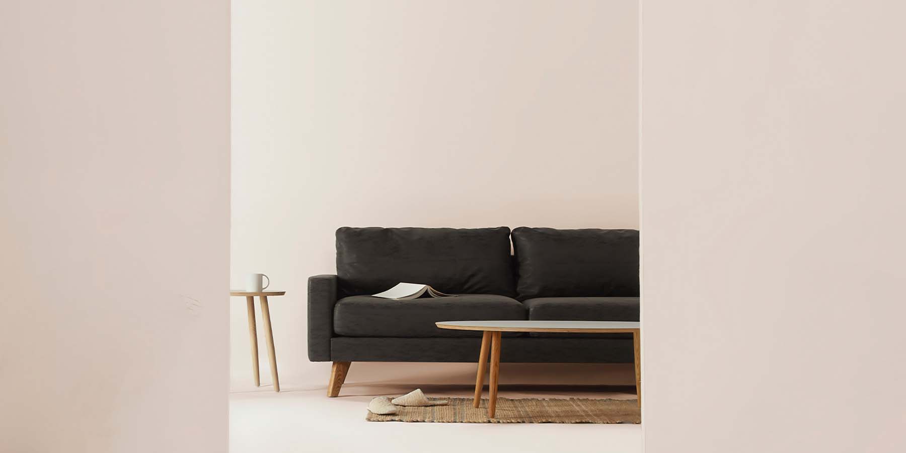 Black couch on a pink living room