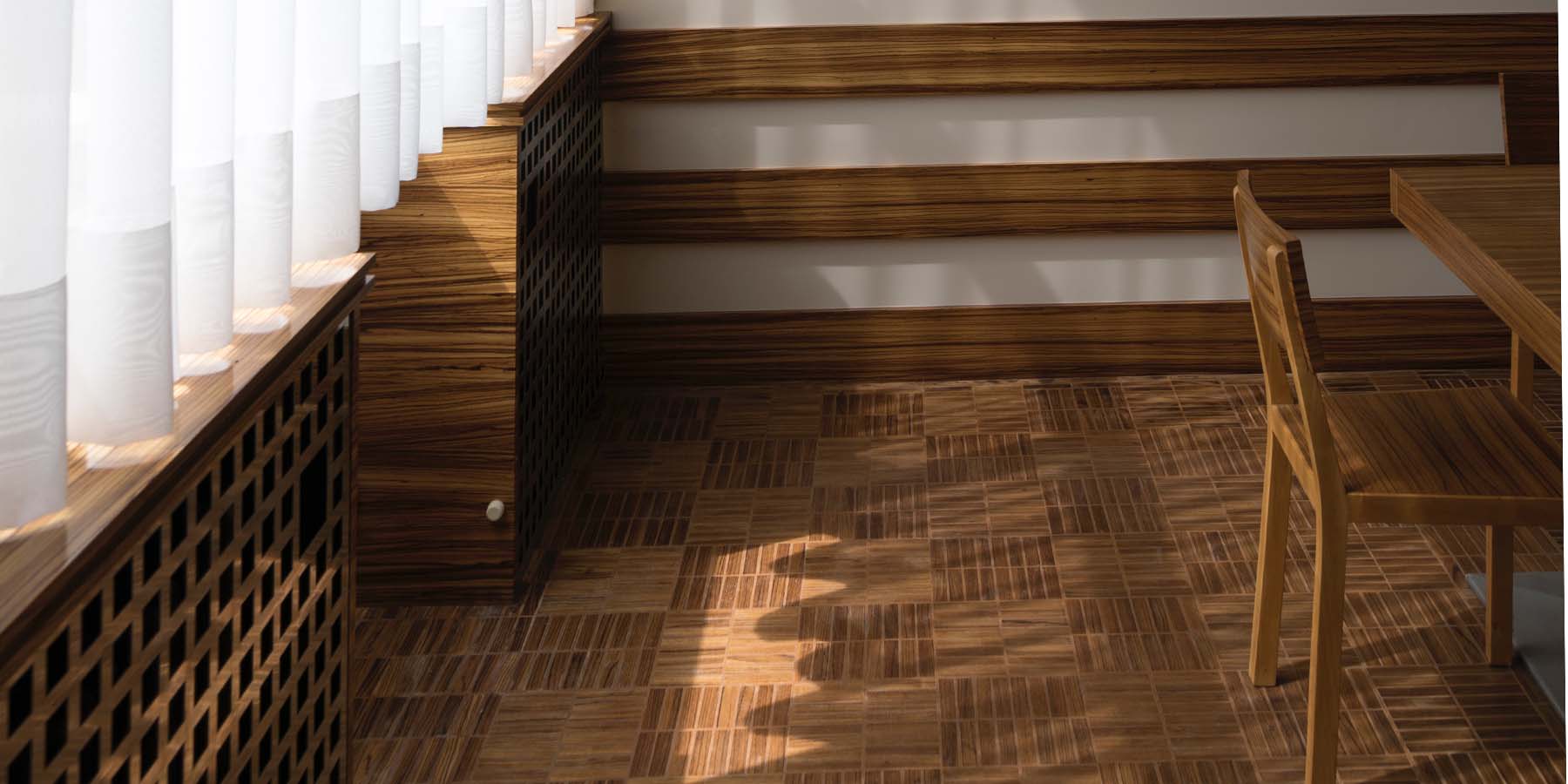 Natural light coming through a large window into a dinning room with wood furniture.