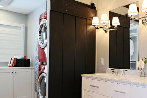 Black Sliding Barn Door Separating The Laundry Room From The Bathroom