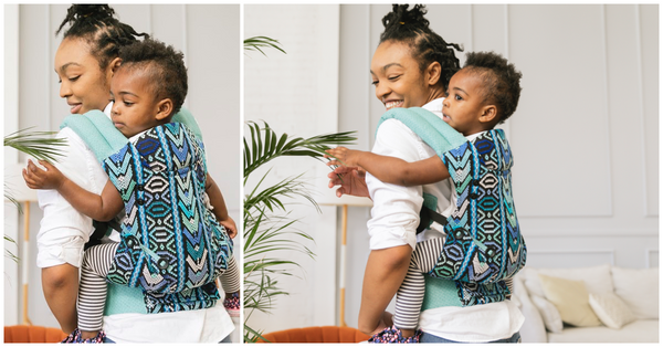 A mother and her curious child using the Tula Baby Carrier in back carry position.