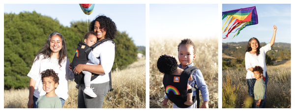 A happy family of four - one mother is carrying their child in a baby carrier.