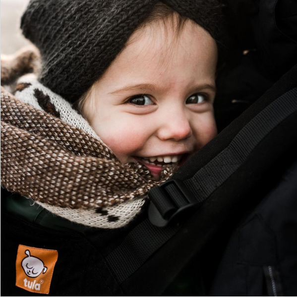 A closeup of a child laughing into the camera.