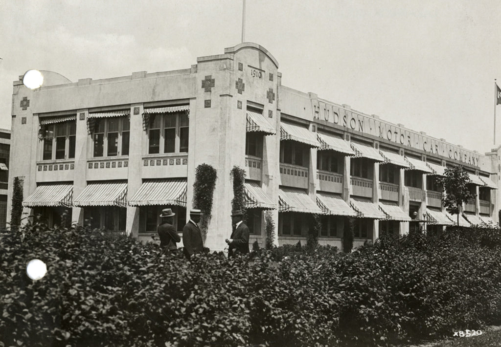 Sepia-toned photo of the Hudson Motor Car Company designed by Albert Kahn with prominent, custom Pewabic tile panels on the building's exterior.