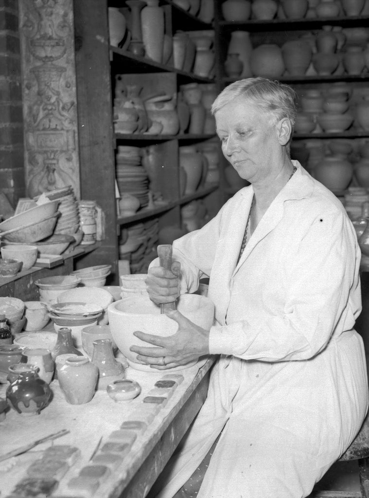 Black and white portrait of Pewabic Co-Founder Mary Chase Perry Stratton mixing glaze elements at the pottery.