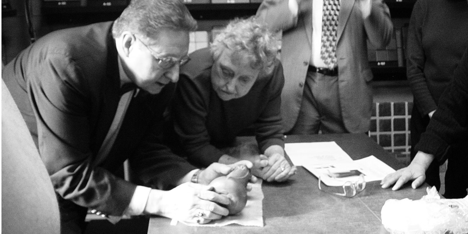 Photo of Pewabic’s first archivist, Thomas Brunk, examining the Snowdrop vase acquired by Pewabic in 2005.