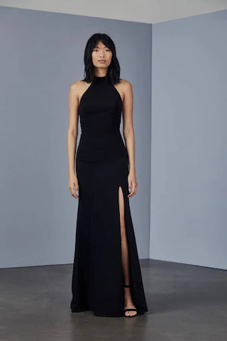 Halter-neck sleeveless full-length black gown with split at thigh.