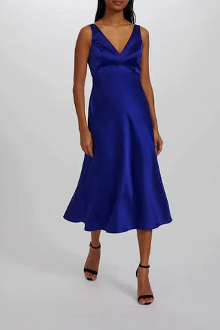 Cobalt blue midi dress with V-neckline, wide straps, an empire waist and an open back cutout detail with delicate buttons.