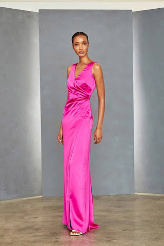 Full-length evening gown shown in fuschia (available in black). Wrap-style dress with v-neck front and back.