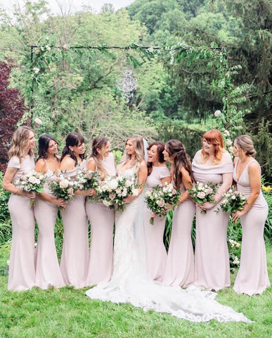 Bride and bridesmaids posing in backyard