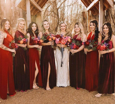 Bridesmaid in white dress posing with bridesmaids in red dresses