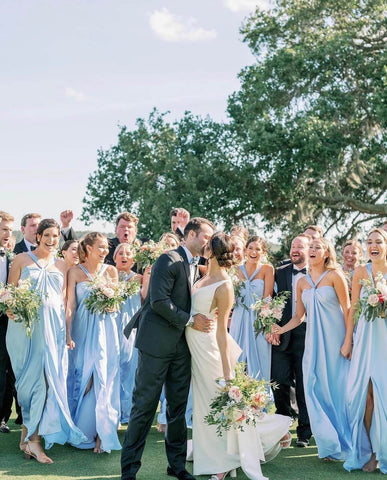 Bride and groom having a first look at their wedding surrounded by their bridal party