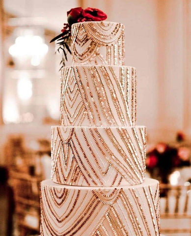 Ivory wedding cake decorated with gold trim