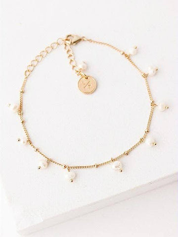 Dainty freshwater pearls dance along your wrist to add a little romance to your everyday.