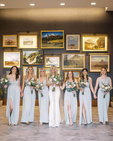 Bride and bridesmaids in art gallery
