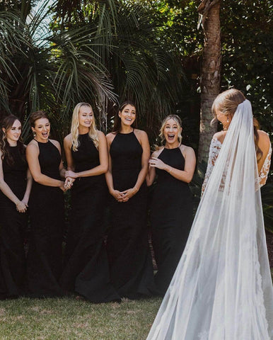 Bridesmaids reacting to bride's dress