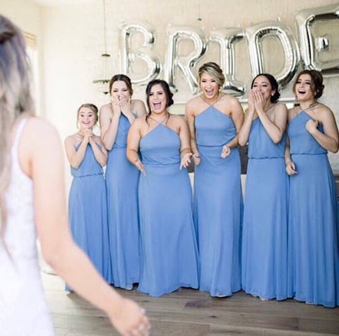 first look of bride to her bridesmaids (who are all dressed in blue)