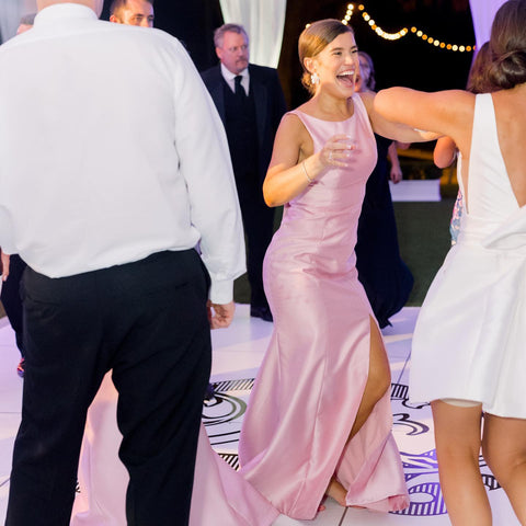 Bridesmaid and wedding guests dancing