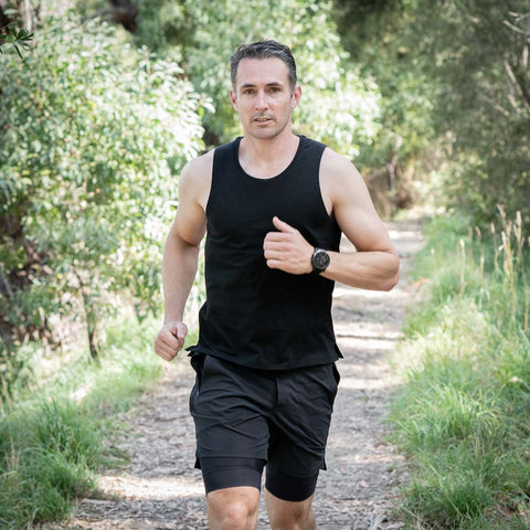 Image of Morgan running on a trail wearing an ioMerino Ultra Tank.