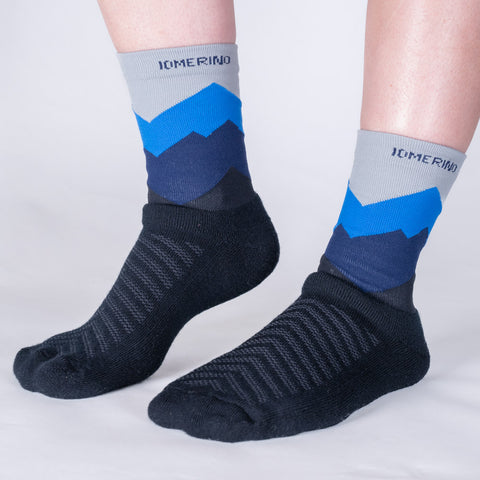 Model wearing ioMerino's Unisex Mullet Trail Socks in Blue