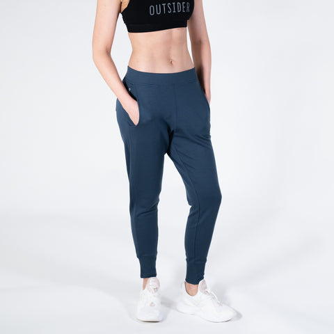 Model wearing ioMerino's Women's Stride Track pants in Navy