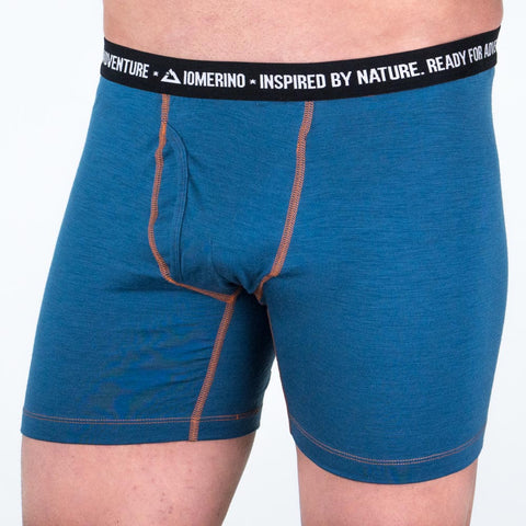 Model wearing ioMerino's Men's Altitude Boxers - Ready for Adventure in Blue with Orange stitch