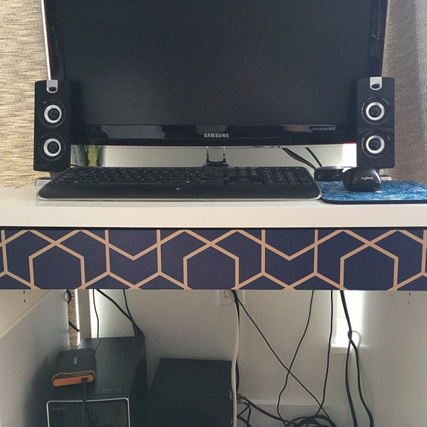 Peel and stick wallpaper on a TV stand