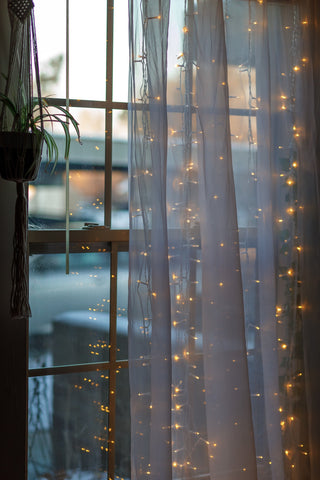 fairy lights over a window curtain