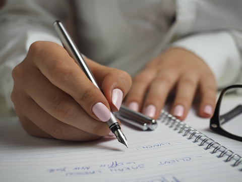 How to make a to do list that works - Sweeter Life Blog - woman writes a list on paper
