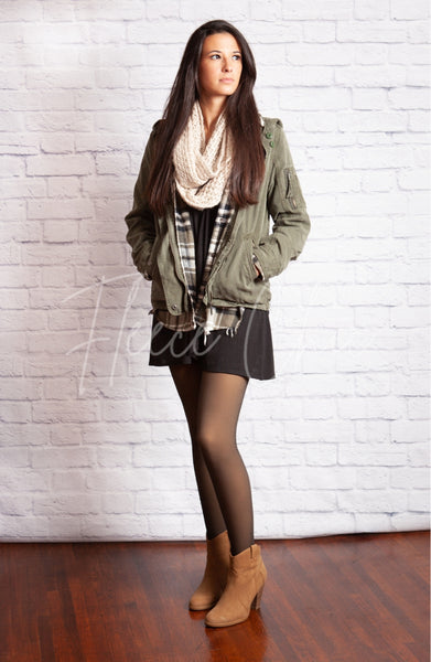 Leggings that look like stockings are worn with a short black dress and brown boots - Fleece Chic