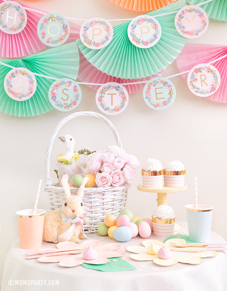 Easter Party Set up for Kids with pastel bunting garlands, daisy plates, letter banner that spells "Happy Easter" styled by Momo Party