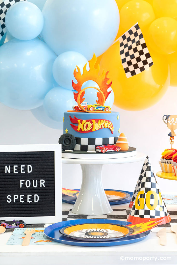 Hot Wheels Party Table Setting Featuring Momo Party's Midnight Blue Dinner Plates, Wheel Shaped Plates, checkered party cups, checkered birthday hats.
