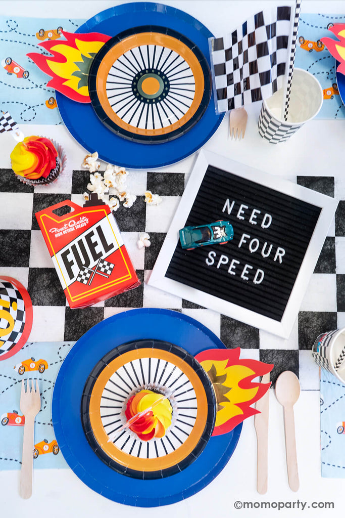 Need FOUR Speed Hot Wheels themed kid's fourth birthday party table setting ideas featuring Momo Party's wheel shaped plates with flames paired with the classic blue round plates, with checkered flag accents, it's a party that guarantees a roaring success!