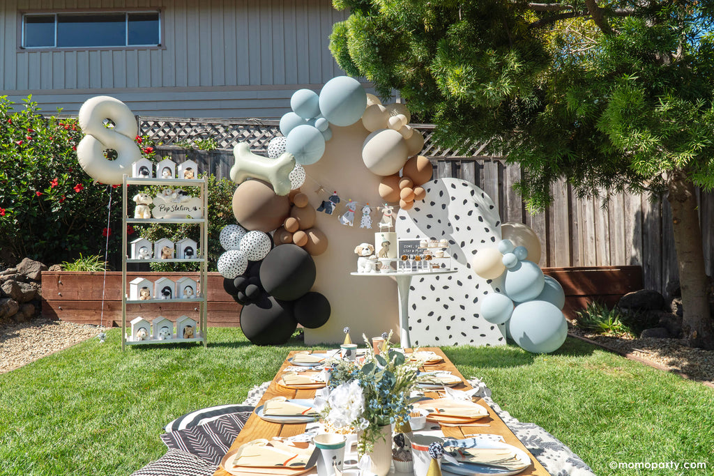 Momo Party Puppy Dog Themed Kid's Birthday Set Up with balloon garlands, bone shaped foil balloon and Dalmatian print balloons in soft colors