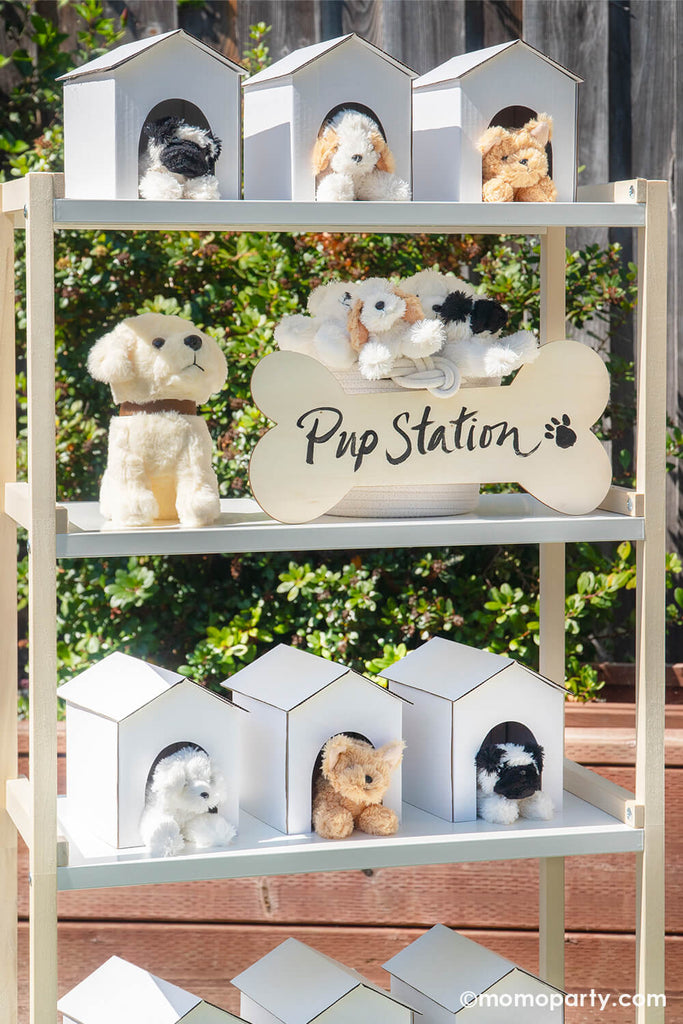 Momo-Party_IT’S-PAW-TY-TIME_Puppy-dog Themed-Birthday-Party_Pup-Station shelf close up filled with doghouses and plush puppies as party favors for kids.