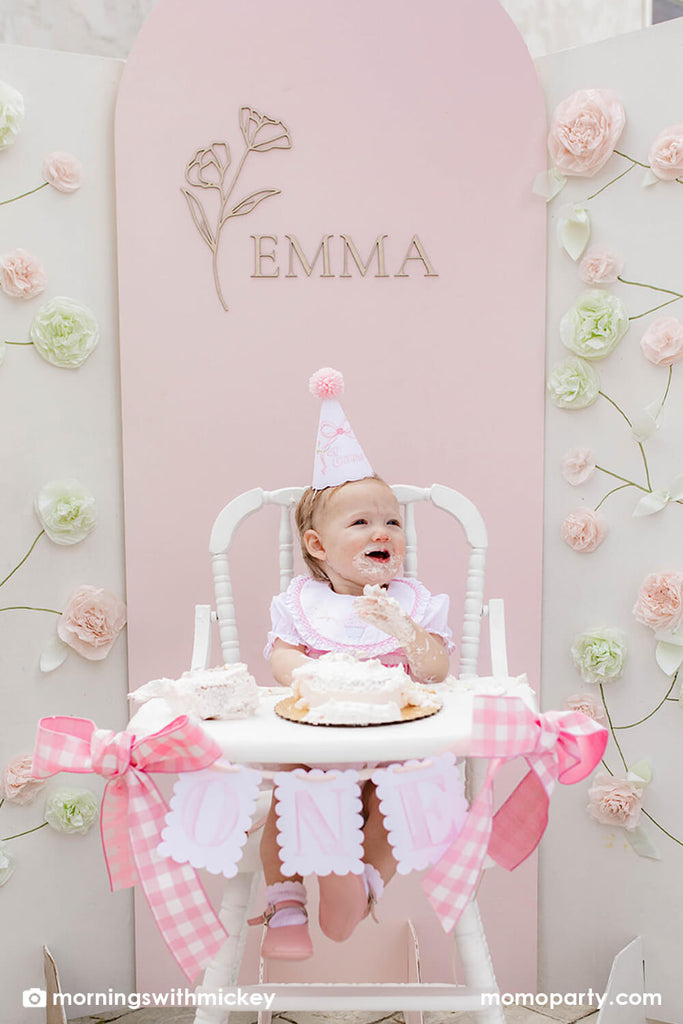 Momo Party_Baby girl's first birthday party ideas baby in high chair with smash cake