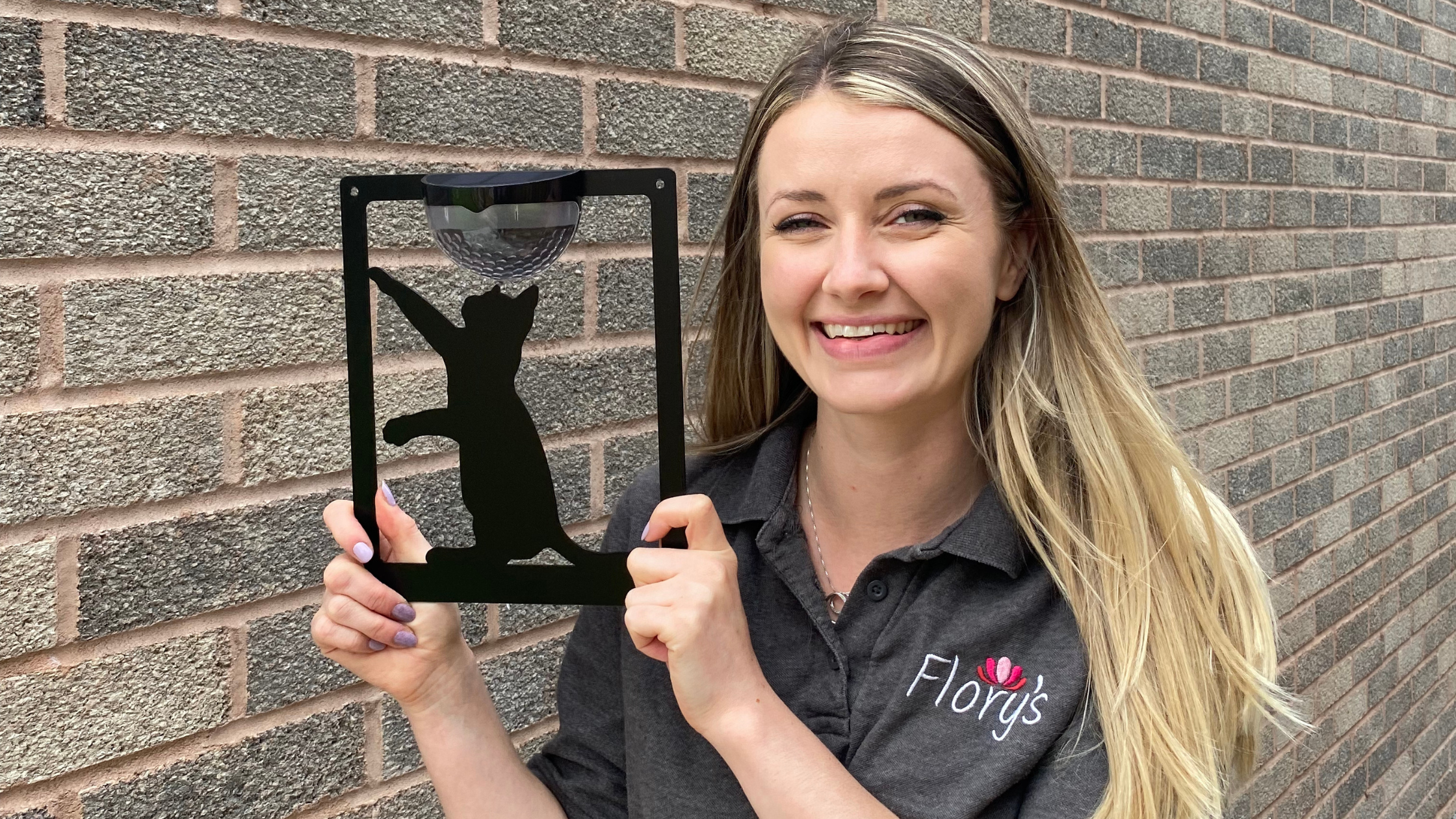 Flory's Online - Jess Flory with Cat Solar Wall Light infront of brick wall