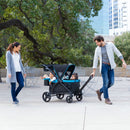 Load image into gallery viewer, Baby Trend Expedition 2-in-1 Stroller Wagon PLUS family of four with dad pulling wagon of two children sitting in wagon
