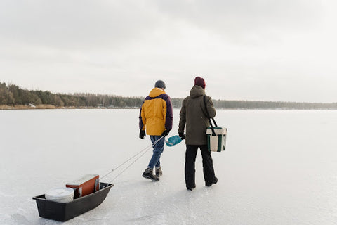 Two people going ice fishing